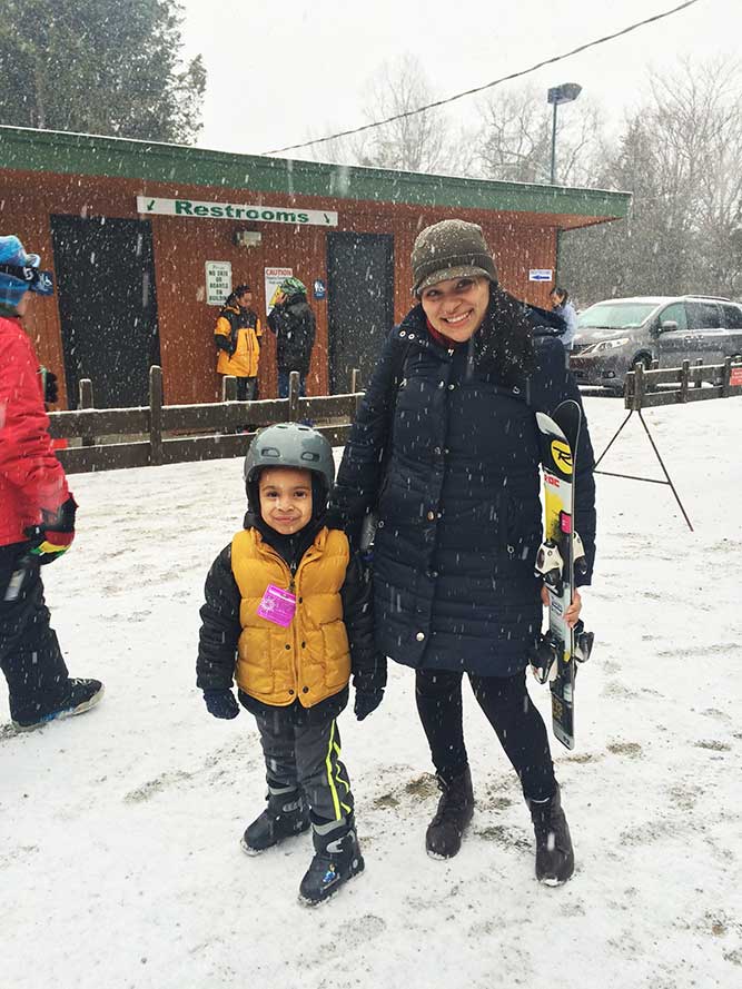 Instructor guiding Elias on the beginner slope