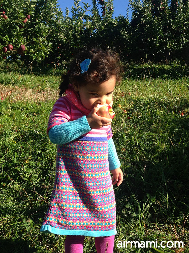 Child tasting an apple